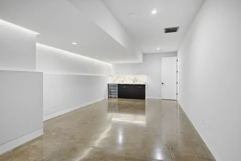 a view of an empty room with a window and fireplace