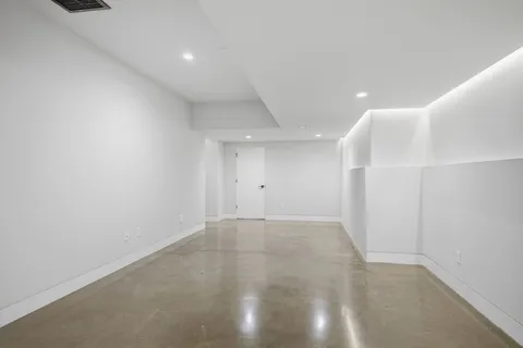 an empty room with furniture and a window