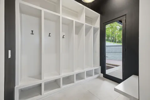 a view of an empty room with cabinet and a chandelier