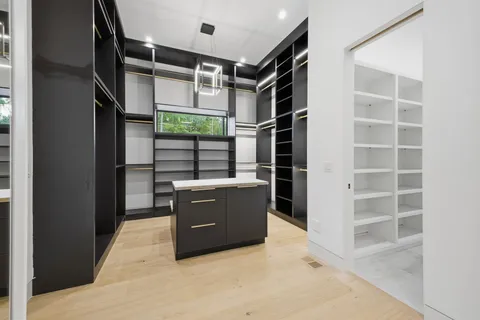 a view of an empty room with closet and window