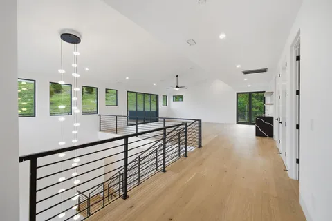 an empty room with ceiling fan and window