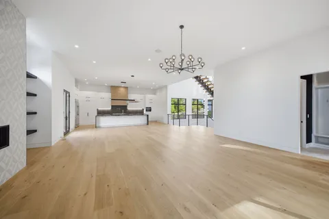 a bedroom with bed and a chandelier
