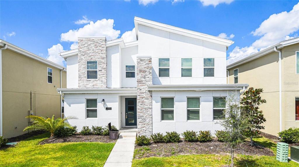 front view of a brick house with a yard