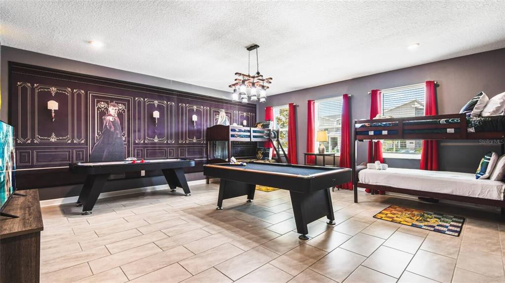 2916 Simile Street Kissimmee, FL 34746 - Photo 13 of 55 a living room with furniture a piano and a chandelier