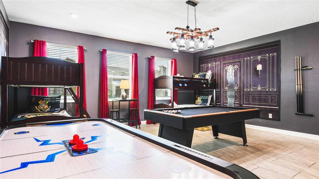 2916 Simile Street Kissimmee, FL 34746 - Photo 15 of 55 a living room with furniture and a chandelier