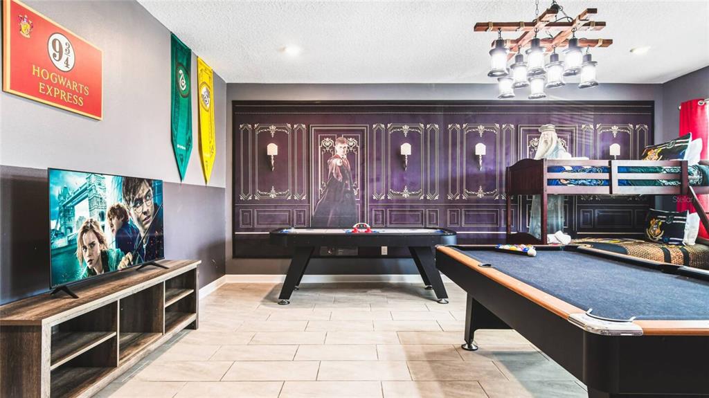 2916 Simile Street Kissimmee, FL 34746 - Photo 16 of 55 a living room with furniture a flat screen tv and a chandelier