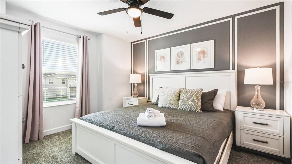 2916 Simile Street Kissimmee, FL 34746 - Photo 17 of 55 a bedroom with a bed and ceiling fan