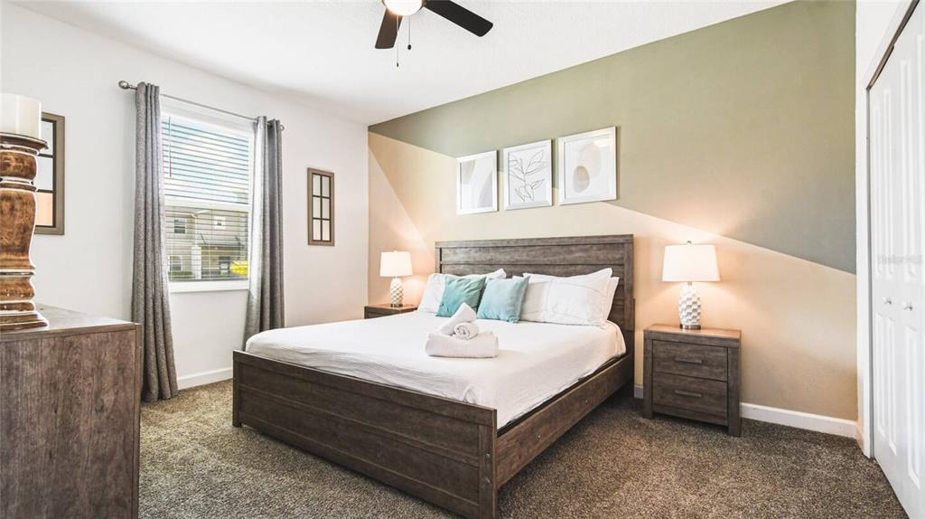 2916 Simile Street Kissimmee, FL 34746 - Photo 18 of 55 a large bed sitting in a bedroom next to a window