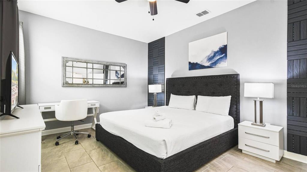 2916 Simile Street Kissimmee, FL 34746 - Photo 20 of 55 a bedroom with a bed and a table