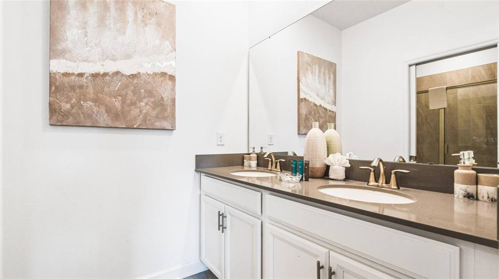 2916 Simile Street Kissimmee, FL 34746 - Photo 25 of 55 a bathroom with a double vanity sink and a mirror