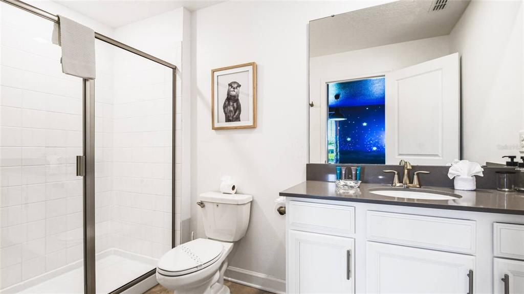 2916 Simile Street Kissimmee, FL 34746 - Photo 28 of 55 a bathroom with a granite countertop sink toilet and shower