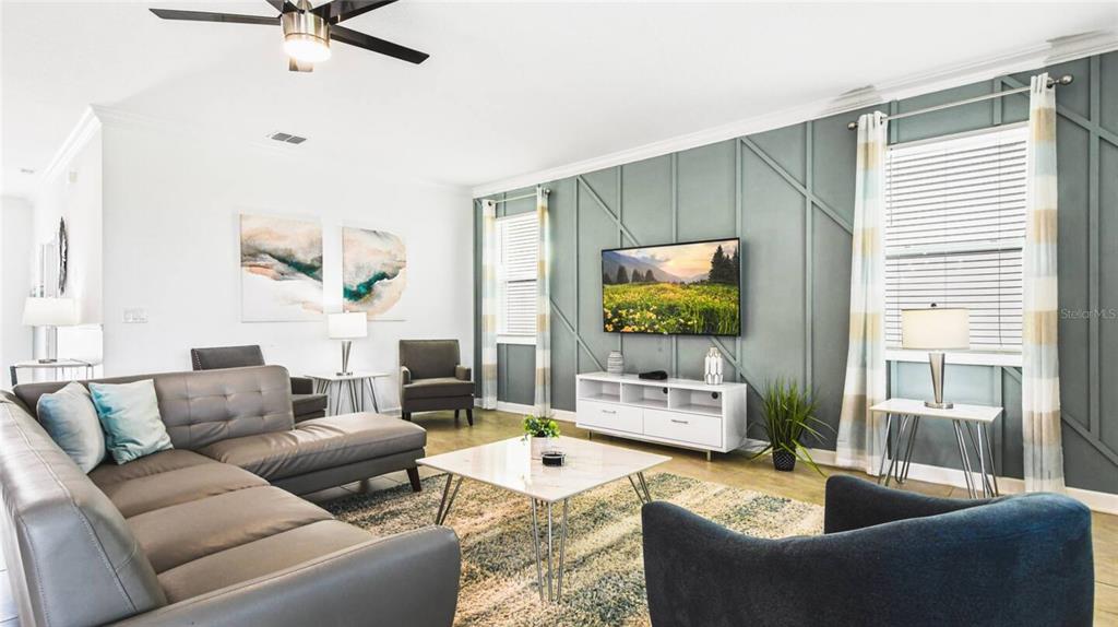 2916 Simile Street Kissimmee, FL 34746 - Photo 3 of 55 a living room with furniture and a flat screen tv