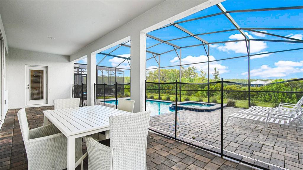 2916 Simile Street Kissimmee, FL 34746 - Photo 31 of 55 a view of a patio with a table and chairs