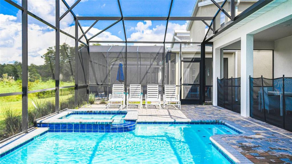 2916 Simile Street Kissimmee, FL 34746 - Photo 33 of 55 a backyard of a house with barbeque oven table and chairs