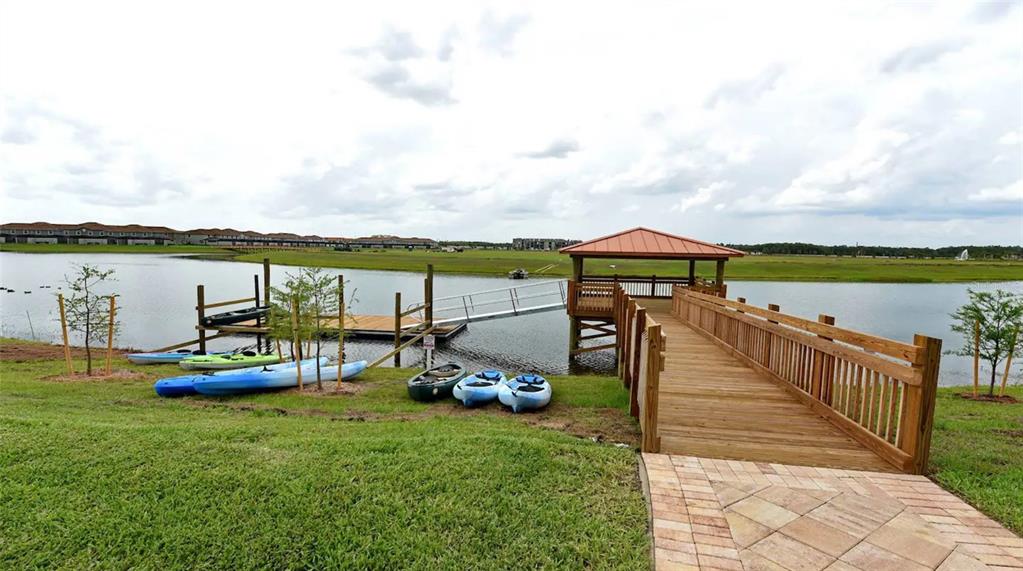2916 Simile Street Kissimmee, FL 34746 - Photo 49 of 55 a view of a lake with a table and chairs