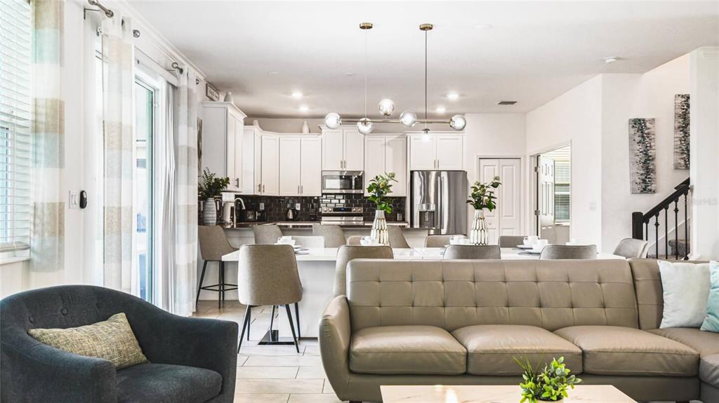 2916 Simile Street Kissimmee, FL 34746 - Photo 6 of 55 a living room with furniture and a chandelier
