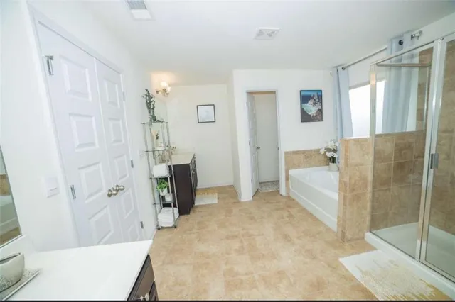 a bathroom with a tub shower and sink
