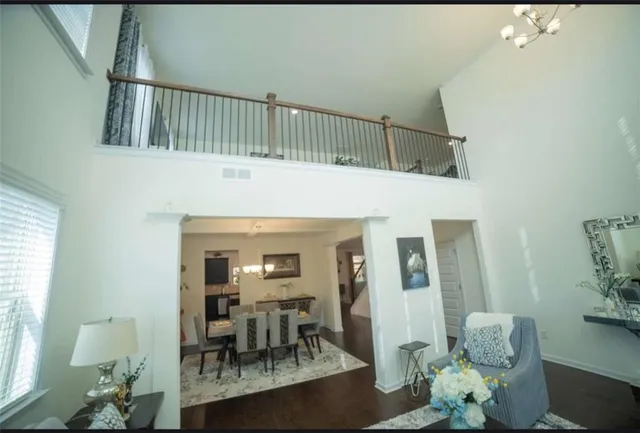 a living room with furniture and a dining table