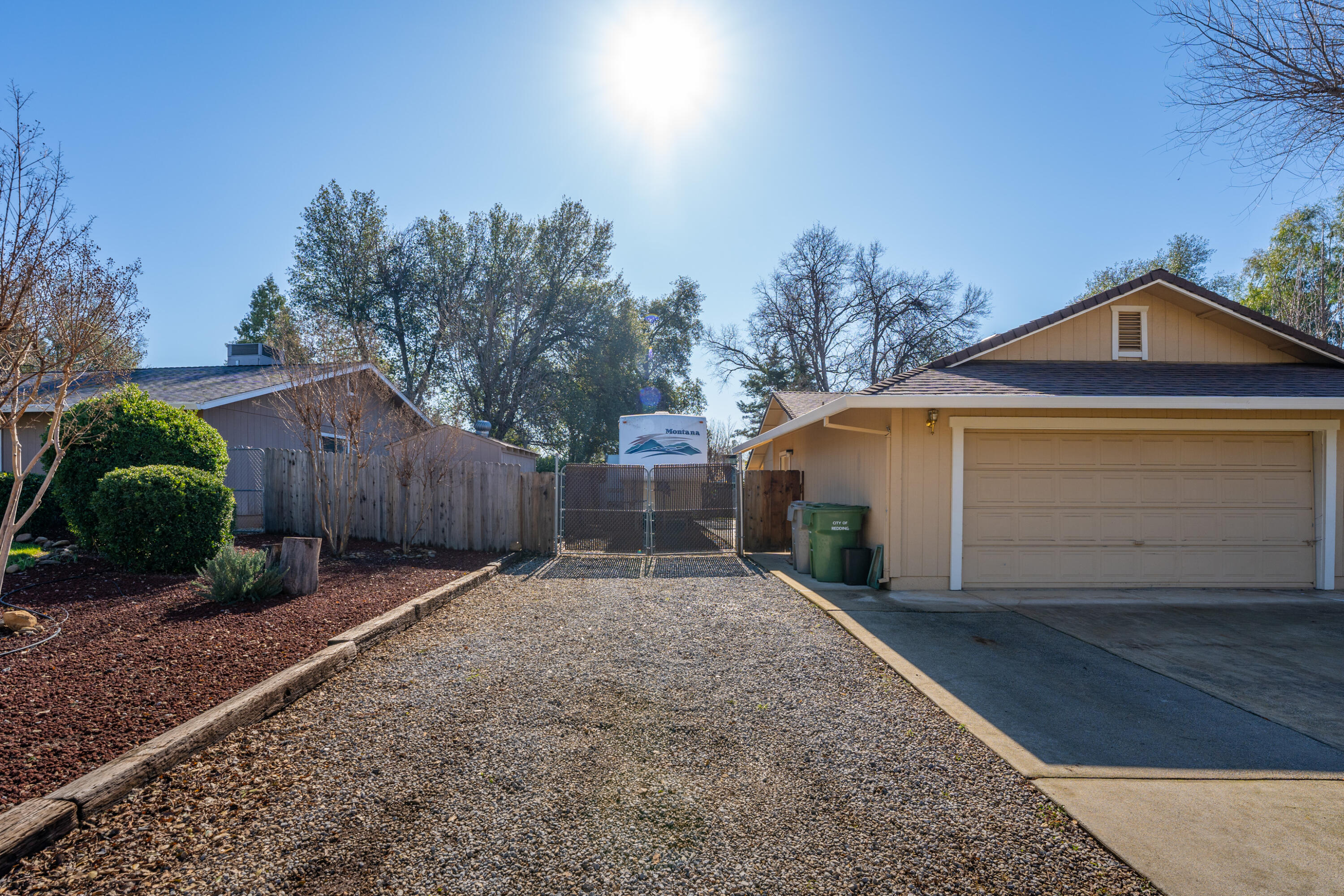 853 Oakmont Drive Redding, CA 96003 - Photo 27 of 37 a front view of a house with a yard and garage