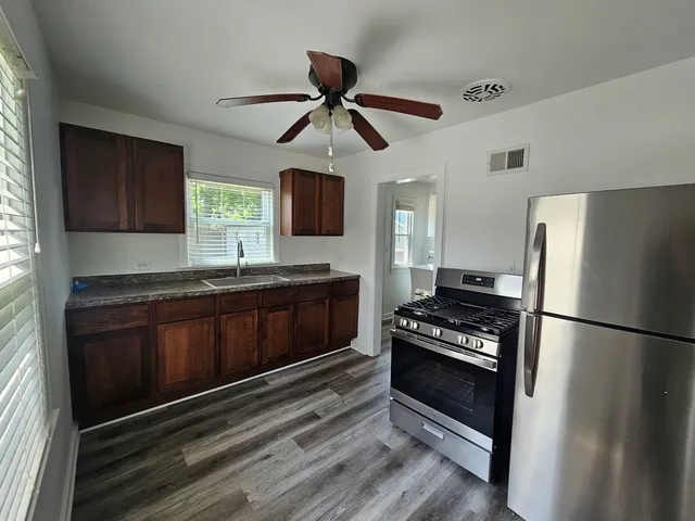 a kitchen with a refrigerator stove and a sink