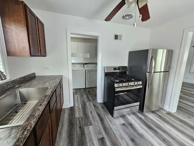 a kitchen with a refrigerator and a sink