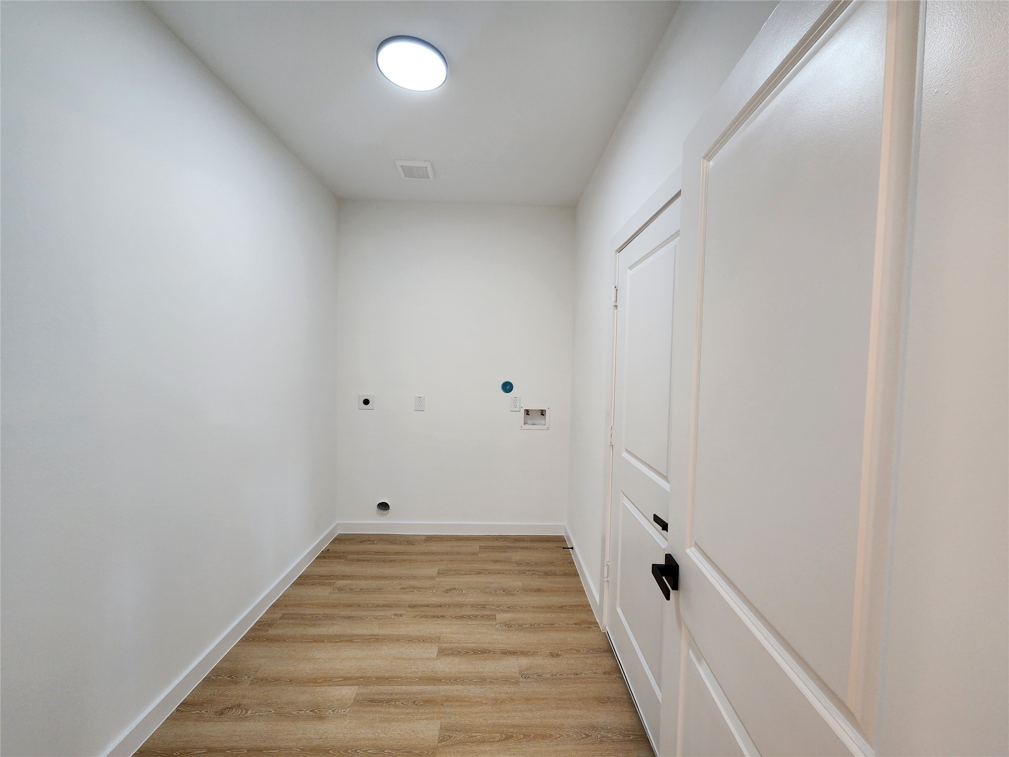 7817 Beckley Street, Unit A Houston, TX 77088 - Photo 7 of 18 a view of a room with wooden floor and white walls