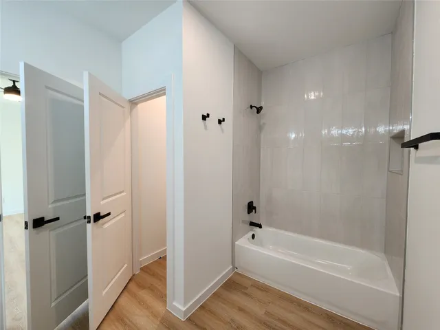 a bathroom with a bathtub and a shower