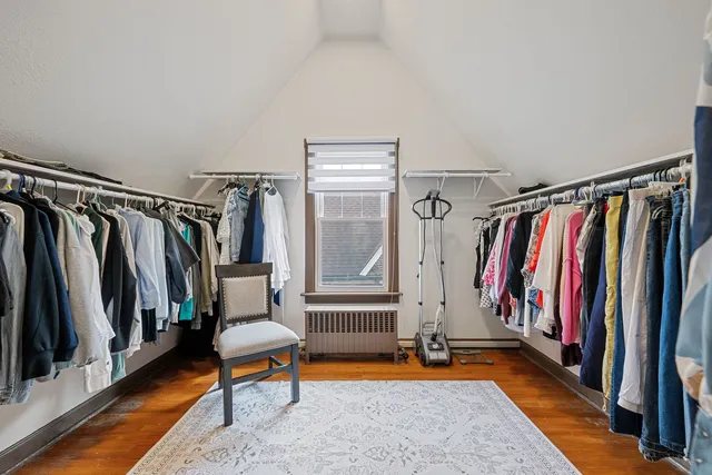 a view of walk in closet with clothes and shoes