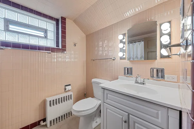a bathroom with a sink a toilet and a mirror