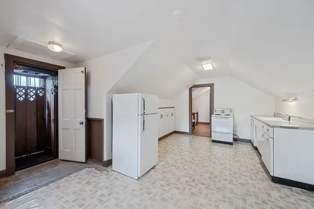 a view of a kitchen with refrigerator and dishwasher