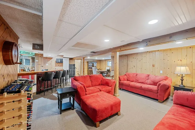 a living room with furniture a rug and a flat screen tv