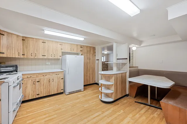 a kitchen with refrigerator cabinets and wooden floor