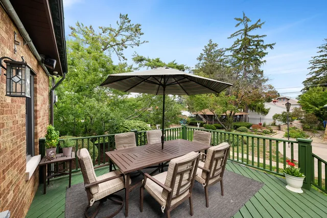a view of a deck with furniture and a yard