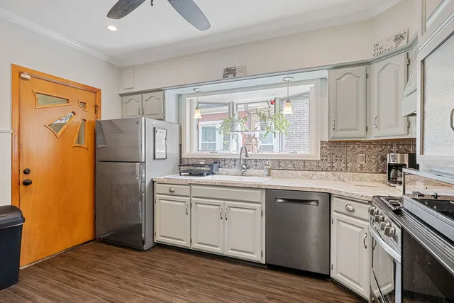a kitchen with a refrigerator sink and cabinets