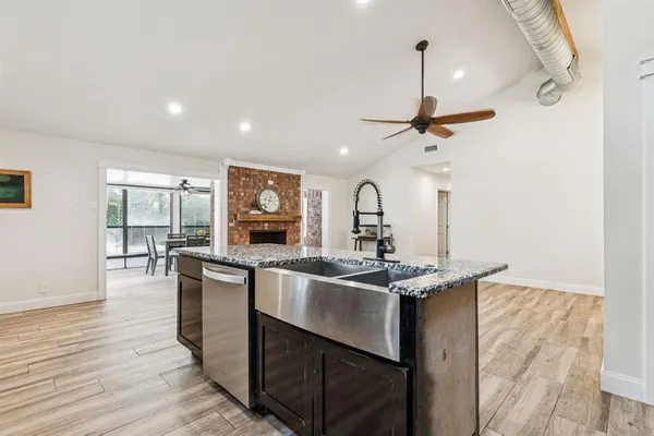 a kitchen with stainless steel appliances granite countertop a sink and stove