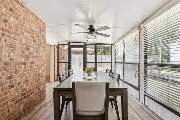 a dining room with furniture a chandelier and wooden floor