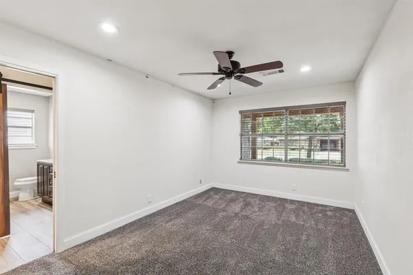 a view of a livingroom with a ceiling fan and window