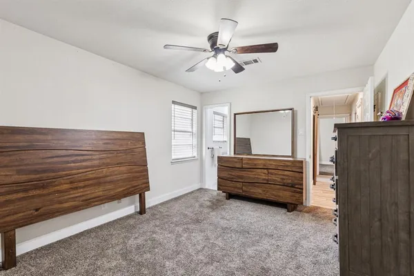 a view of room window and a ceiling fan