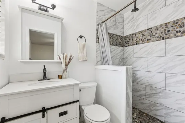 a bathroom with a sink toilet and shower