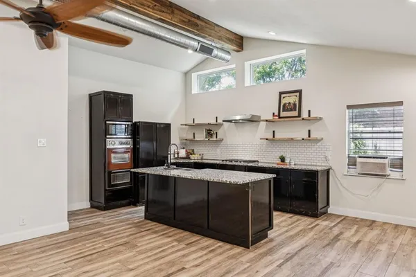 a kitchen with stainless steel appliances granite countertop a stove and a refrigerator