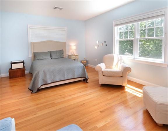 75 Page Road Lincoln, MA 01773 - Photo 16 of 25 a spacious bedroom with a bed couch and a large window