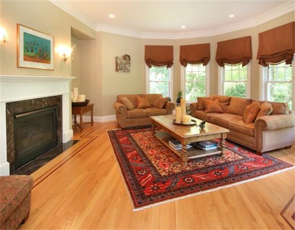 75 Page Road Lincoln, MA 01773 - Photo 5 of 25 a living room with furniture a large window and a fireplace