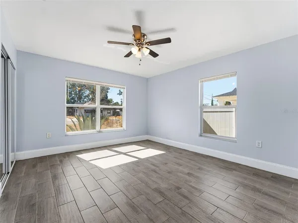 wooden floor in an empty room with a window