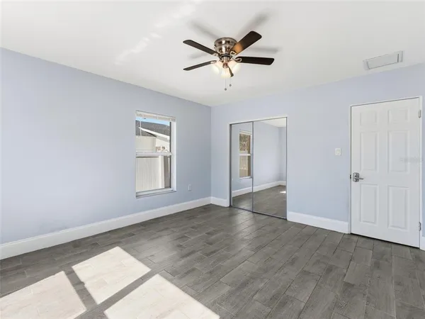 wooden floor in an empty room with a window