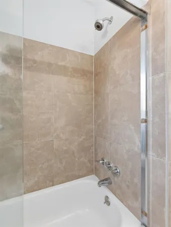 a bathroom with a bathtub and a shower