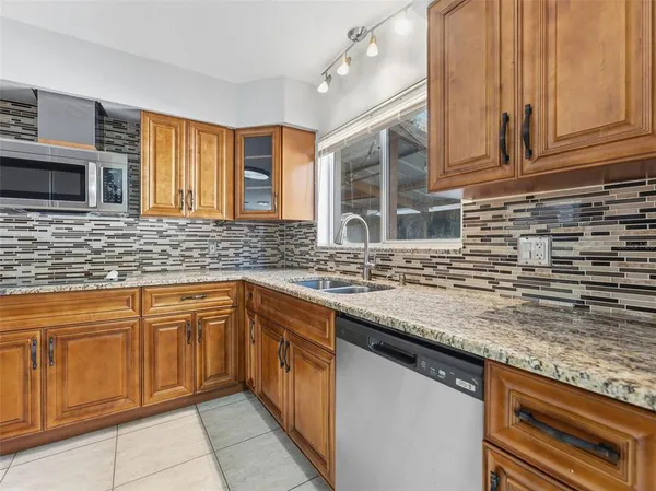 a kitchen with stainless steel appliances granite countertop a sink and cabinets