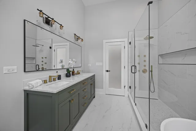 a white bath tub sitting next to a shower