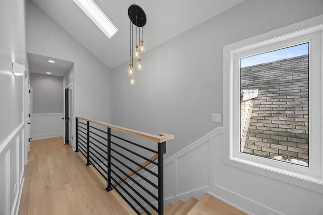 a bedroom with a bed and painting on the wall