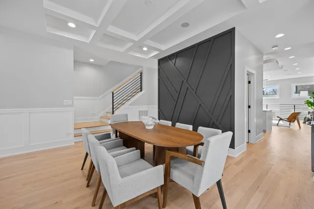 a dining room with furniture and wooden floor