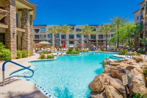 a view of swimming pool with outdoor seating and a yard